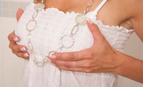 Sexy milf Wendy in fancy skirt exposes big hooters and spreads her legs in the bathroom