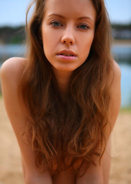 Hot young Natasha S reveals small tits and bald pussy at beach